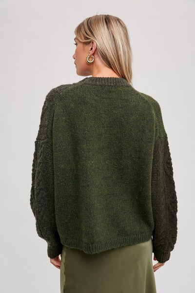 A wardrobe essential, this knitted texture color block sweater is designed with a soft-touch viscose blend for comfortable all-day wear. With its bold color block pattern and slim-fit silhouette, this sweater is perfect for any occasion.