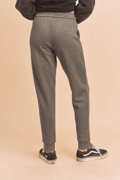 This lounge top is a lightweight yet durable staple, designed in a loose fit with a draped shoulder, and finished with a drawstring. These pants that take you from the gym to wherever you need to go. Designed with split hem at the ankles and two front pockets, these joggers are not only versatile but fashion-forward.