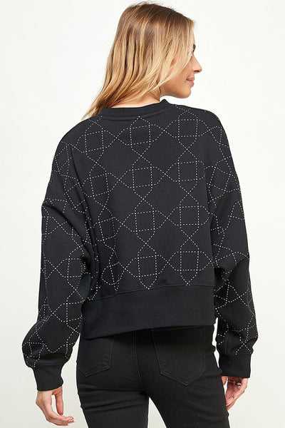 The contrasting quilted pattern on this sweater make it perfectly comfy chic!