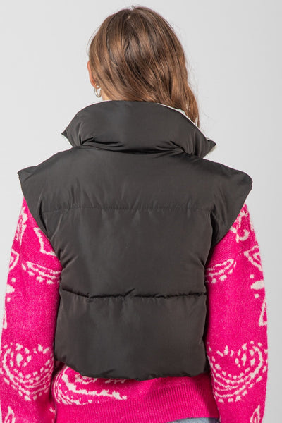 Stay warm and look like a fashionista in this high neck crop puffer vest! With a front zipper, side pockets, and contrast color lining, you'll love rocking this stylish and cozy vest in its bright colors. (Be prepared to turn heads!)