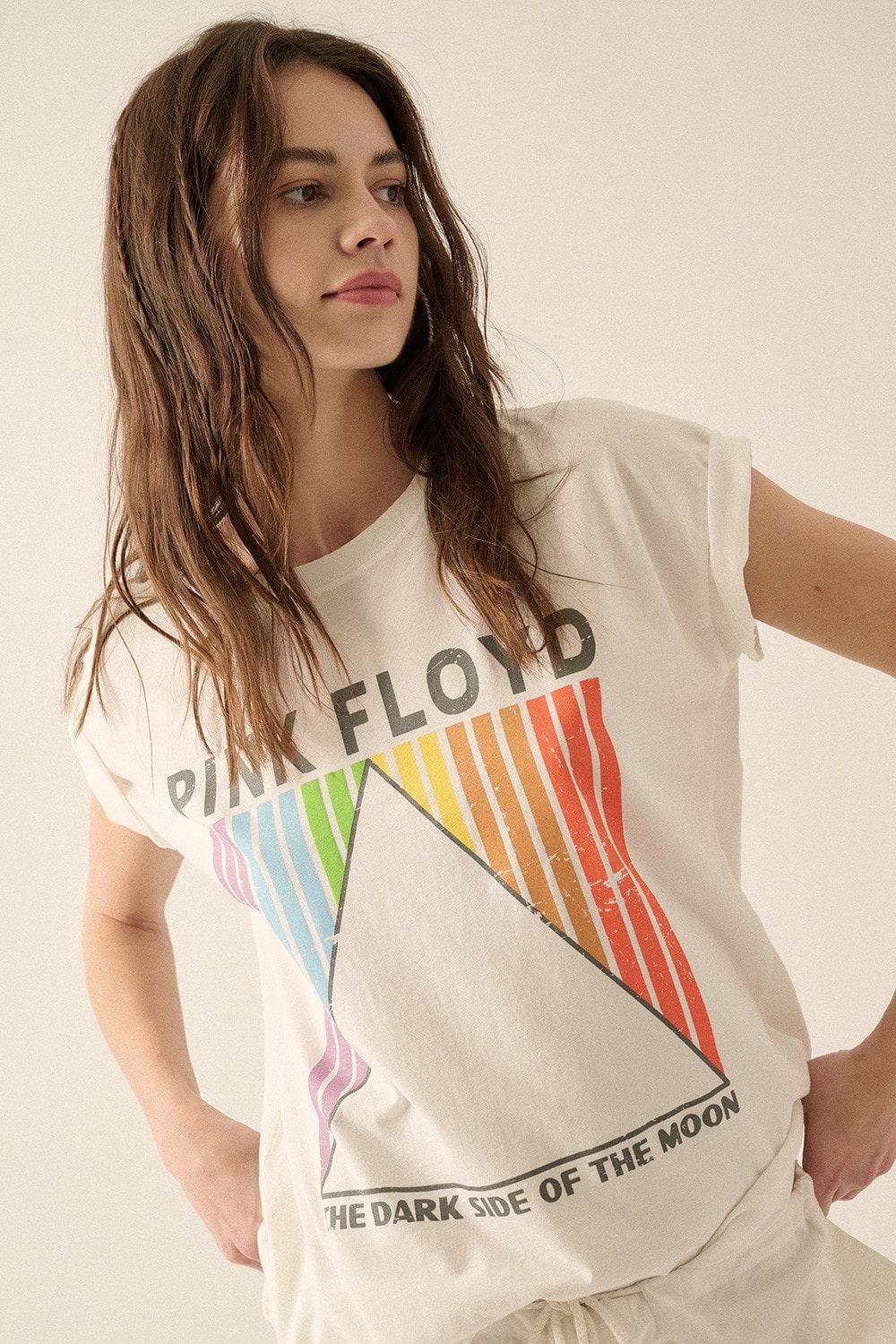 Make a statement with this bold, vintage-style Pink Floyd t-shirt! With a Dark Side of the Moon print, colorful rainbow stripes, and drop shoulder, it'll be the trippiest thing in your wardrobe. Get ready to rock out in style!