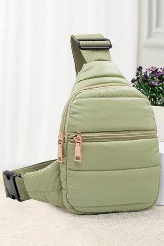 This clever Mini Puffer Sling Bag is the perfect way to tote your stuff in style! In eye-catching sage green, it features an adjustable strap, one inside pocket to store your small items, and a zipper closure to keep everything safe and secure. Whether you're headed to the office or running errands, it'll be your go-to bag!