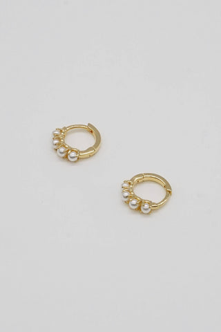 PRODUCT DETAILS MATERIAL ﻿14k gold filled over brass and pearls SIZE 12mm, 1 touch closing DESIGNER NOTE Inspired by the delicate Strive Hoops, these earrings are made to add a touch of classic flair. STYLE TIP: Dainty Pearl Huggies for your dainty ear stack! These small hoops go best with your favorite huggies and cuffs! ALLERGY INFORMATION: Hypoallergenic Handmade in U.S.