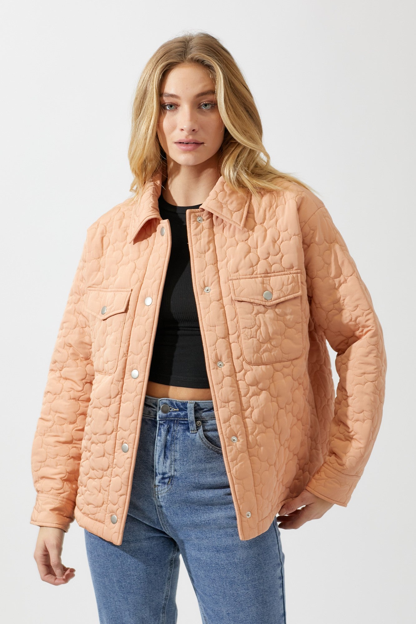 This quilted jacket has the cutest pattern of daisies througout the whole jacket. It'll have you thinking about stopping to smell the flowers all day long! We love this fresh take on a classic button up jacket!