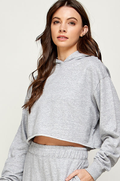 Can there be such a thing as a trendy classic? We say yes, and this sweater will easily fall into that category! We love the timeless color and hoodie, but with the twist of the crop length.