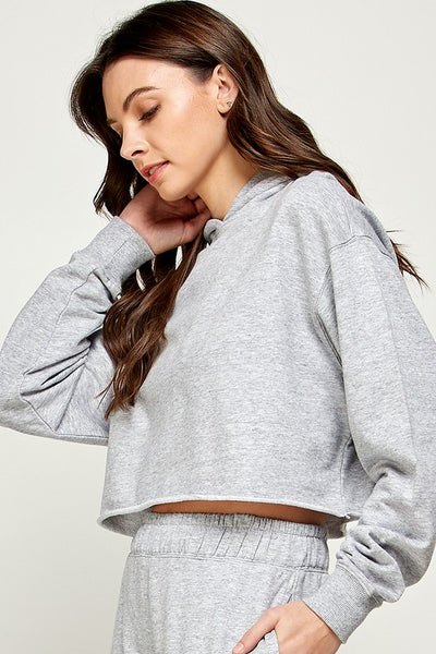 Can there be such a thing as a trendy classic? We say yes, and this sweater will easily fall into that category! We love the timeless color and hoodie, but with the twist of the crop length.