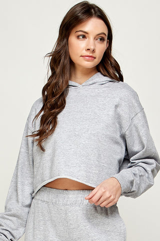 Can there be such a thing as a trendy classic? We say yes, and this sweater will easily fall into that category! We love the timeless color and hoodie, but with the twist of the crop length.