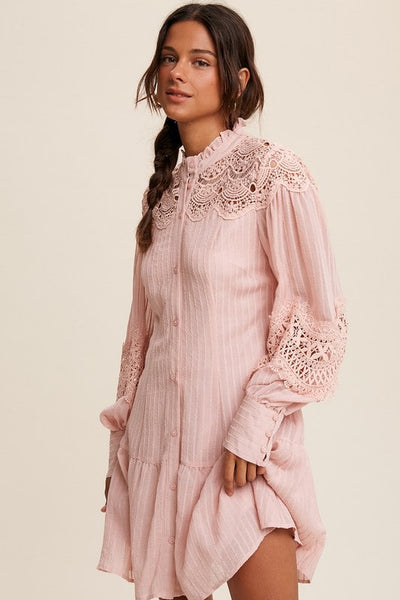 This super lacey dress is boho, girly, and super fun!   - Ruffle mock neck - Bishop sleeve with button on cuffs - Crochet lace detailing - Finished with clan ruffle hem - Lined - Model is 5' 8" 34-25-35 and wearing a size Small