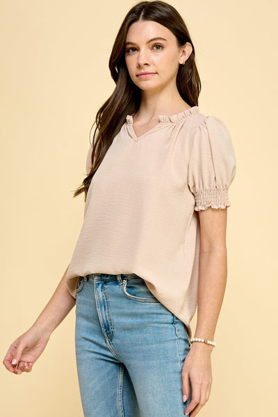 Ruffle neckline, smocked sleeves, and a drapey silhouette: these details are the makings of one of our favorite shirts! We normally don't like any type of drama, but we love it when it comes to our clothes!